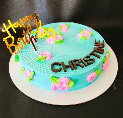 Teal with pink flowers birthday cake