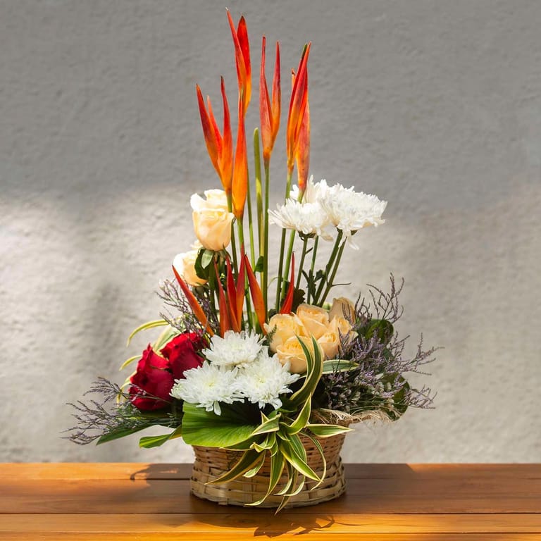 Red and peach roses, chyrsanthemum and B.O.P. in a basket - Image 1