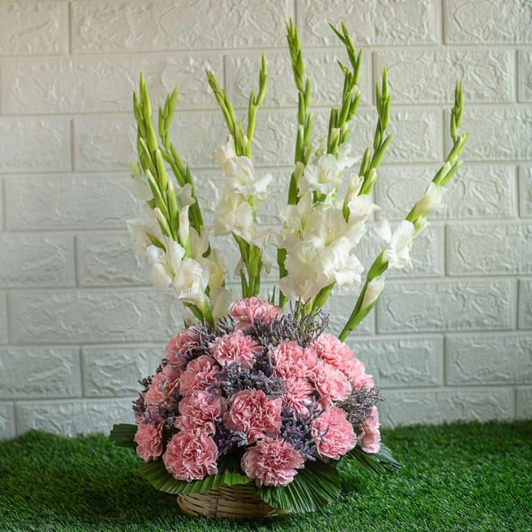 Pink carnations , limonium and gladiolus in a basket - Image 1