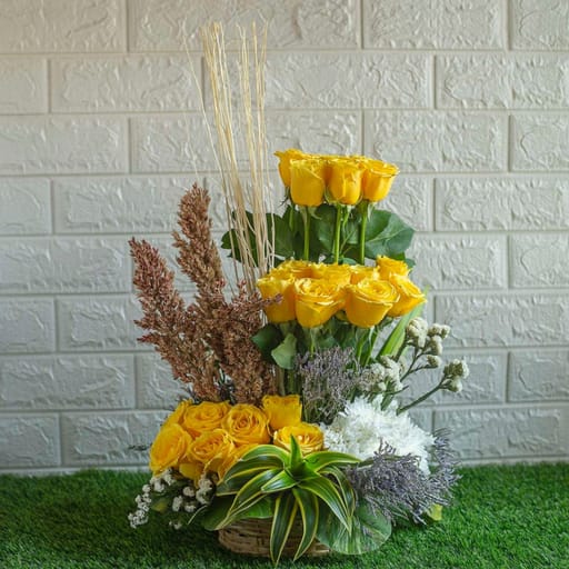 Yellow roses , dry sticks chrysanthemum in a basket