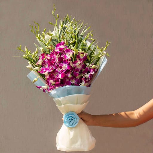 Hand bouquet of orchids and leaves