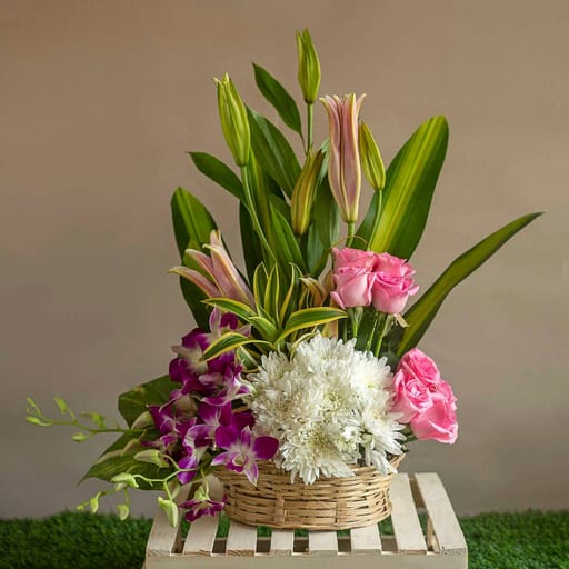Basket of pink roses , white chrysanthemum ,orchids